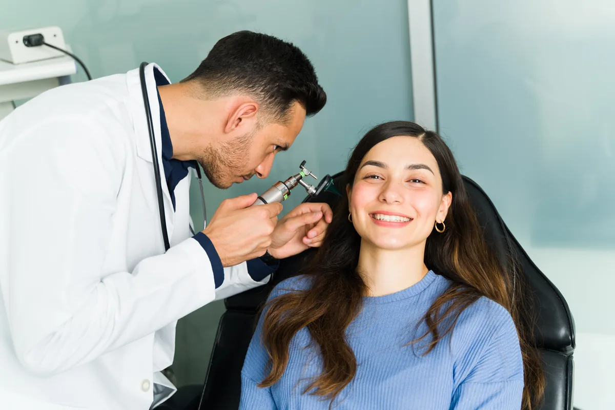 An ENT surgeon reviewing a nasal endoscopy with a patient