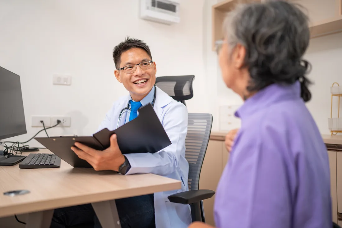Fellowship-trained surgeon consulting with a patient