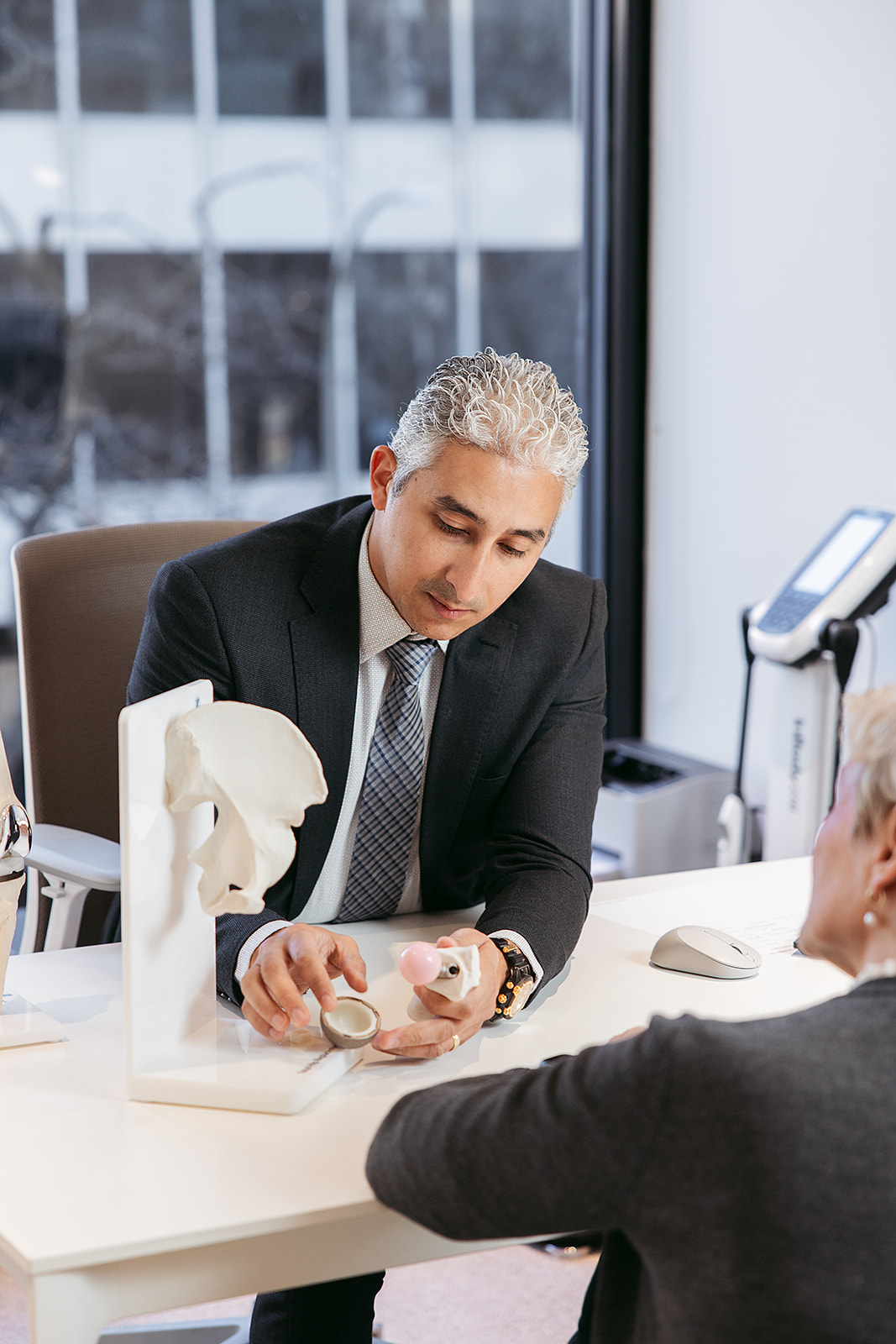 An orthopedic surgeon reviewing a joint scan with a patient