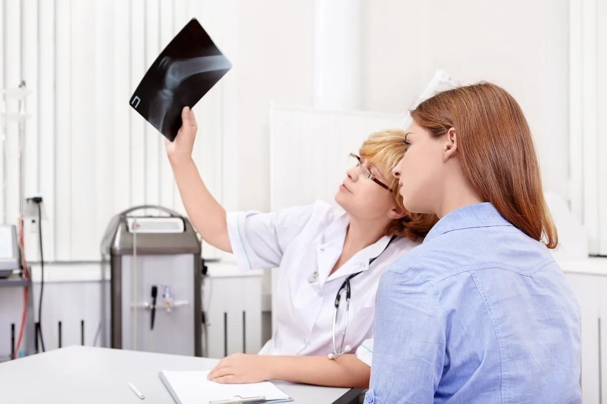An orthopedic surgeon reviewing a shoulder scan with a patient